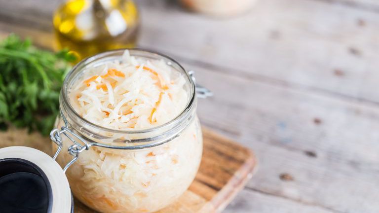 Sauerkraut fermented salad. Homemade fresh pickled cabbage (german sauerkraut) with ingredients in jar